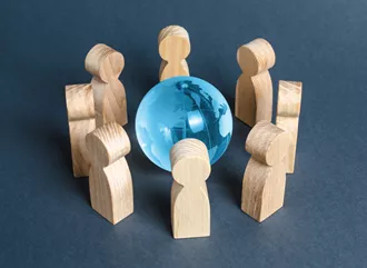People standing around a globe