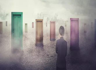 A boy standing in front of many doors