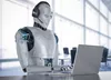 A human looking robot using a laptop and headset