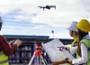 Construction workers using a drone