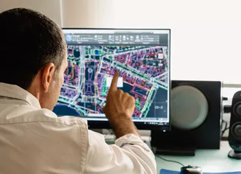 Architect reviewing site map on computer