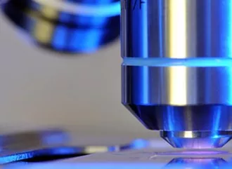 A microscope looking at the detail of a substance in a lab