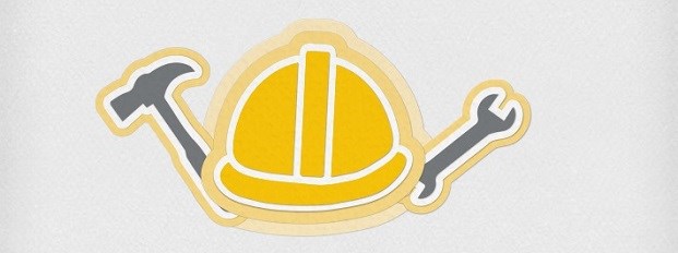 A construction hard hat with a spanner and hammer either side.